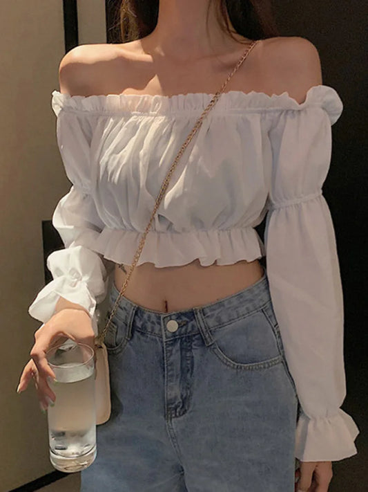 Sexy off-shoulder blouse with dramatic puff sleeves & ruffles! This white crop top features long sleeves for a flirty summer look. Perfect for parties or dates